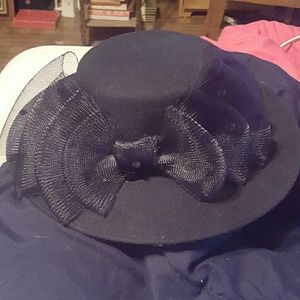 A black hat with beautifully designed bow work